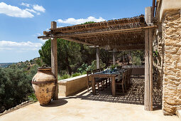 Set dining table and chairs on roofed terrace