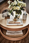Cosmetics and small bouquet on coffee table