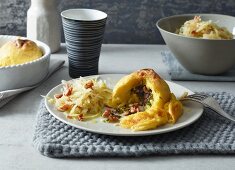 Potato dumplings filled with bacon served with a bacon and cabbage salad