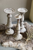 Rustic candlesticks on fur