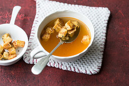 Clear tomato soup with crusty croutons