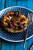 A stuffed mushroom with olives and capers