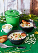 Sour cream soup with vegetables and spiced bacon butter