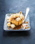 A caramel muffin with popcorn