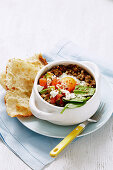 Turkish mincemeat casserole with vegetables and fried egg