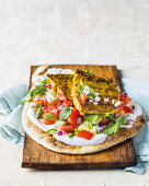 Naan bread with yoghurt, salad, and curry minute steaks