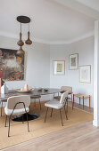 Upholstered chairs at oval table with stone top in dining room