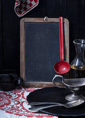 A blackboard and various vintage kitchen utensils