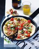 Pan-fried pizza with salsiccia, tomatoes, ricotta and fennel seeds