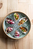 Cooked oysters with beetroot, with chilli nuts and spring onions