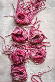 Uncooked homemade beetroot pasta view from above