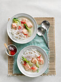 Pho (soup with rice noodles, salmon, vegetables and chili, Vietnam)