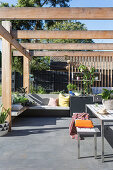 Modern terrace with corner bench, outdoor kitchen and pergola