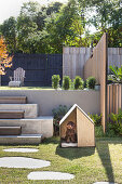 Dog house in the modern garden with two levels