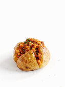 A baked potato with bacon and baked beans