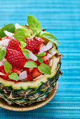 Fruit salad with strawberries served in a hollowed-out pineapple