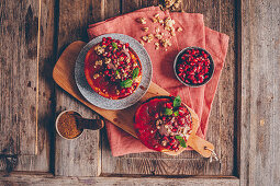 Gratinated grapefruit halves with yoghurt, muesli, pomegranate seeds and mint leaves