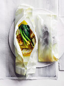 Trumpet fish with curry butter and baby leek cooked in parchment