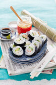 Maki sushi with surimi, cucumber, avocado, ginger, wasabi and soy sauce