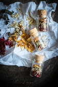 Small jars of loose leaf tea made from dried elderflowers, mint, strawberries and peach