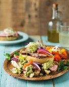 Argentine rump steak with onions, peppers and pesto on ciabatta