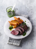 Saddle of venison with chips and a herb sauce