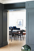 Open doorway with grey panelling leading into living area