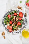 Green asparagus salad with walnuts and strawberries