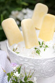 Mango and lime ice lollies in an ice bucket
