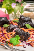 Short ribs with a blueberry glaze and shredded carrot and red cabbage