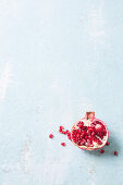 A halved pomegranate on a white surface