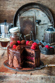 Chocolate cake with raspberry jelly and chocolate truffles, sliced