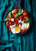 Mediterranean fried tomatoes and peas with chorizo and eggs