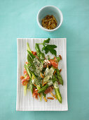 Asparagus with parma ham and roasted pine nuts