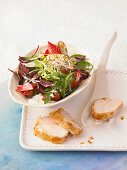 Spring salad with coconut chicken, strawberries and rose dressing