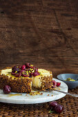 Pistachio and labne cheesecake with cherries and pistachios