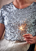 Woman holding sparklers at Christmas