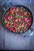 Homemade chocolate bark with goji berries and pistachios in a metal container