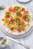 Pavlova with strawberries and exotic fruit