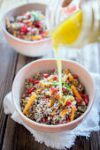 Quinoa bowl with a lemon and mustard dressing and pomegranate seeds