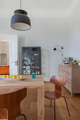 Modern wooden furniture and pale grey walls in dining room