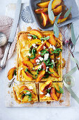 Goat's cheese and fennel tart with polenta pastry and roasted peaches