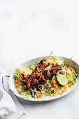 Indonesian chicken skewers and spicy coconut salad