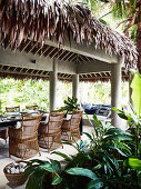 Table and rattan chairs on covered terrace