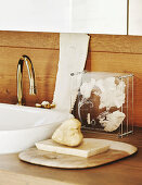 Soap dish next to sink on wooden washstand