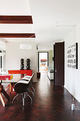 Glass table and designer chairs in elegant dining room