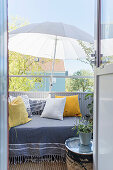 Cushions on couch and parasol on balcony