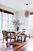 Wooden table with classic chairs and rustic bench in the dining area