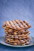 A stack of bubble waffles with icing sugar
