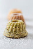 Mini Bundt cakes with pistachio nuts, poppyseeds and icing sugar